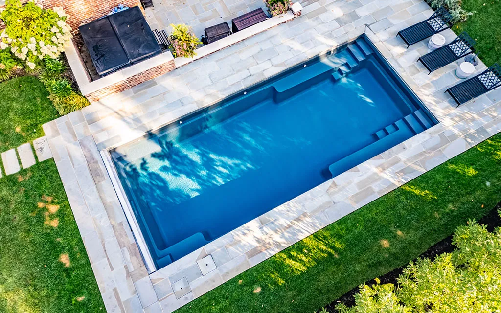 Drone view of a Leisure Pools inground fiberglass pool Transforming Ordinary Yards into Extraordinary Retreats